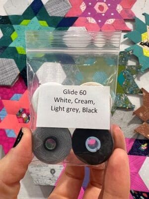 A person holding up two rolls of paper