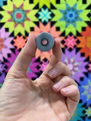 A person holding a small object in their hand.