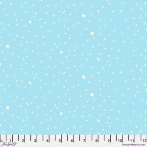 Light blue fabric with white snowflake pattern and ruler for scale.