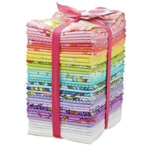 Stack of colorful fabric bundles tied with a pink ribbon.