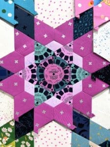 Intricate geometric star pattern with pink and black details.