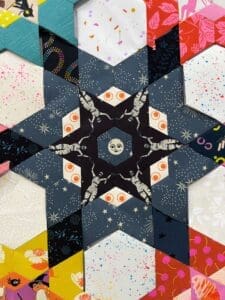 Close-up of a star-shaped quilt with skull and crossbones fabric patterns.