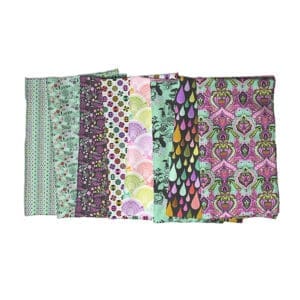 A selection of colorful patterned fabric pieces laid out in a row.